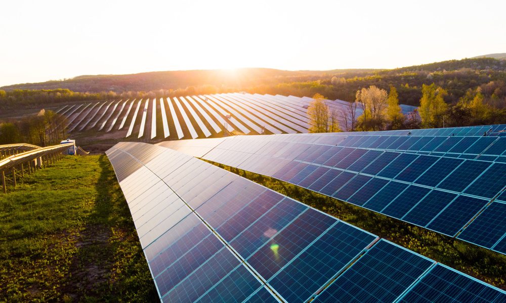 Solar panels reflecting light on solar farm